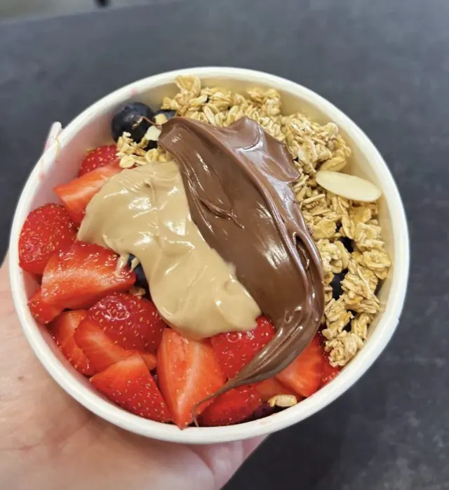 Açaí bowl with strawberries, granola and nut butter